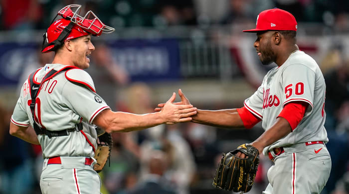 Phillies relief pitcher Héctor Neris celebrates with catcher J.T. Realmuto after beating the Braves.